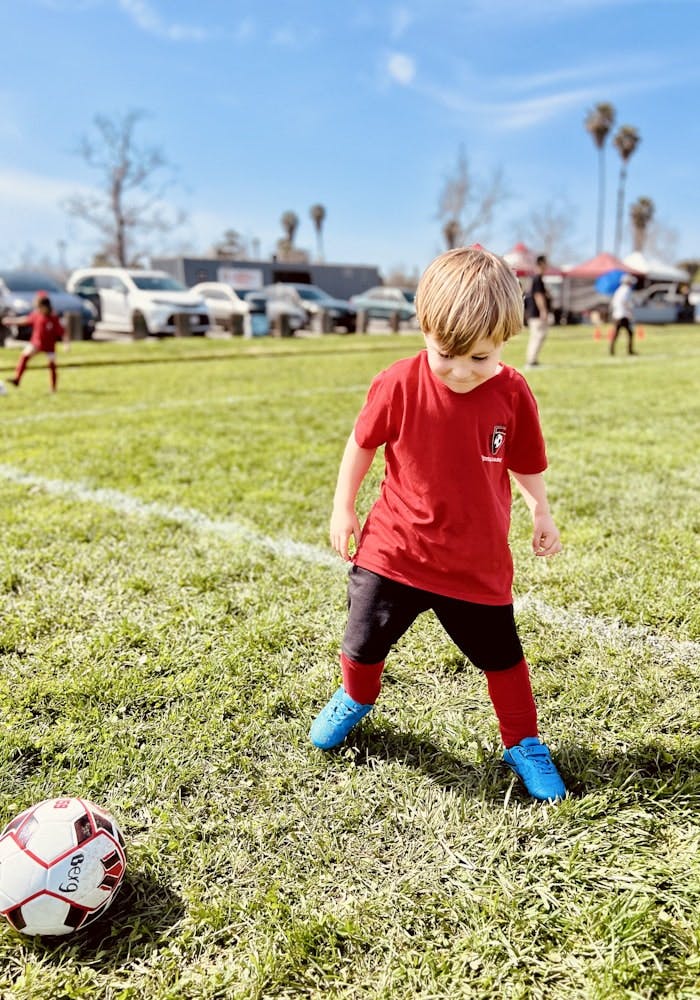 Img: soccer, soccer ball, sport, sphere, boy, child, male, person, car, vehicle