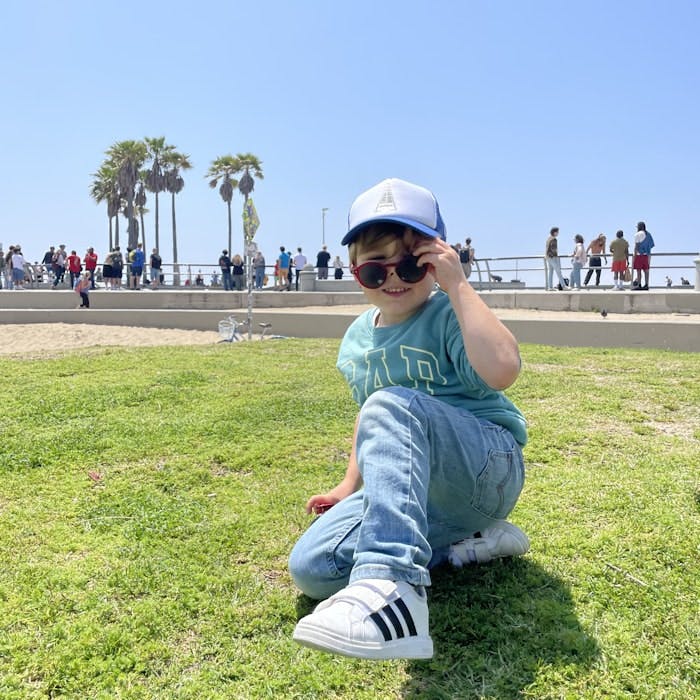 Img: grass, park, baseball cap, cap, hat, pants, tree, summer, person, shoe