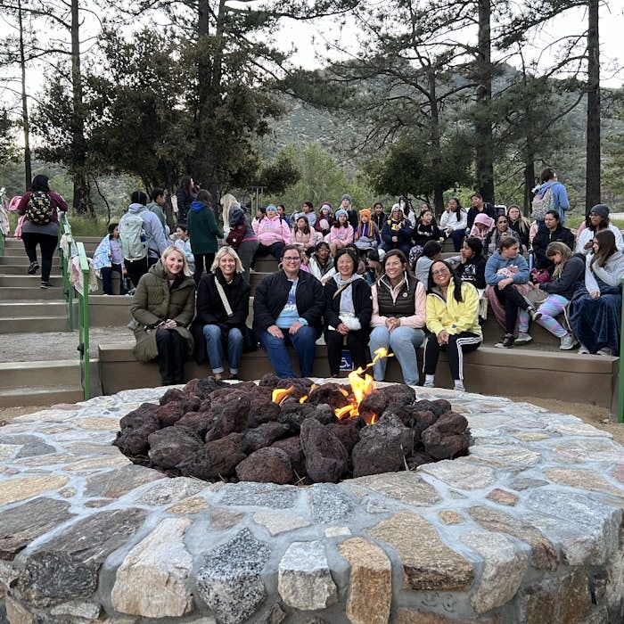 Img: park, rock, people, person, tree, flame, vegetation, pants, handbag, shoe