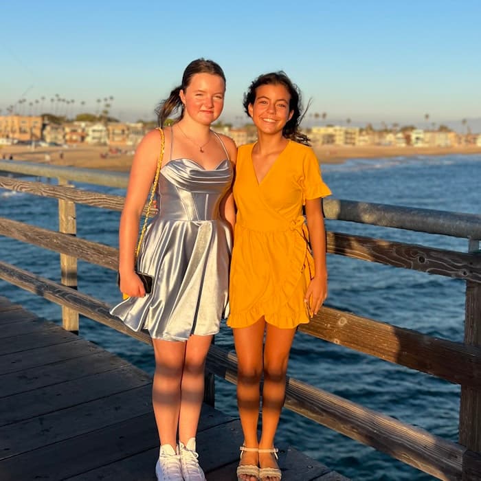 Img: waterfront, dress, evening dress, formal wear, boardwalk, pier, person, handrail, sandal, wood