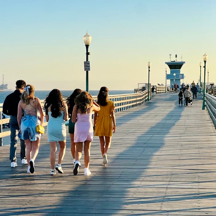 Img: water, waterfront, pier, boardwalk, person, walking, shoe, handbag, path, shorts