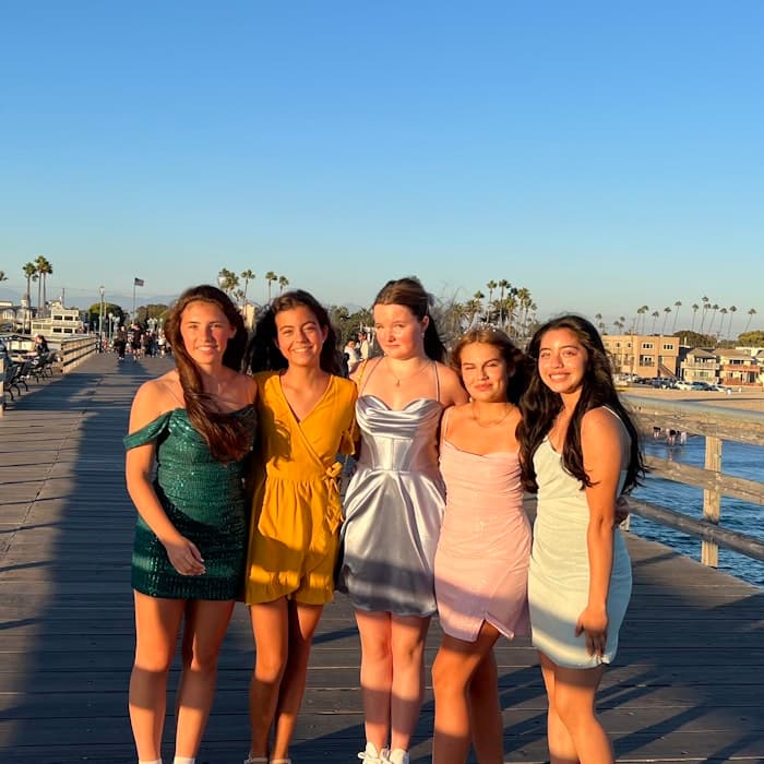 Img: boardwalk, waterfront, shorts, female, girl, person, teen, sandal, shoe, skirt